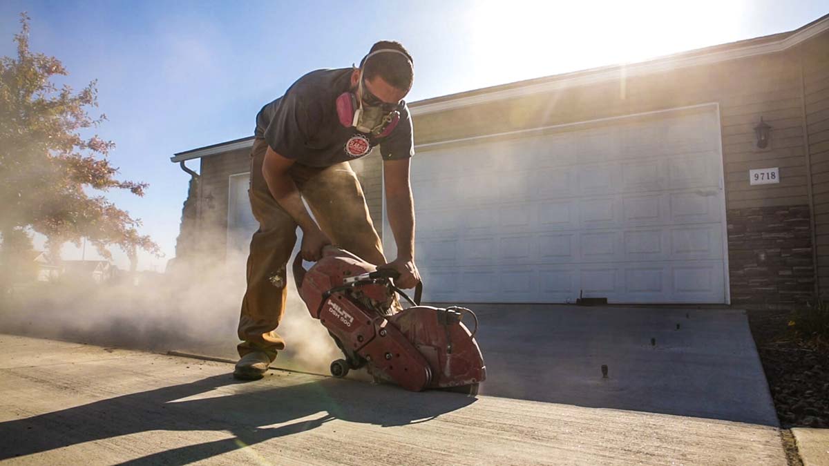 Concrete contractor using a large machine to cut concrete