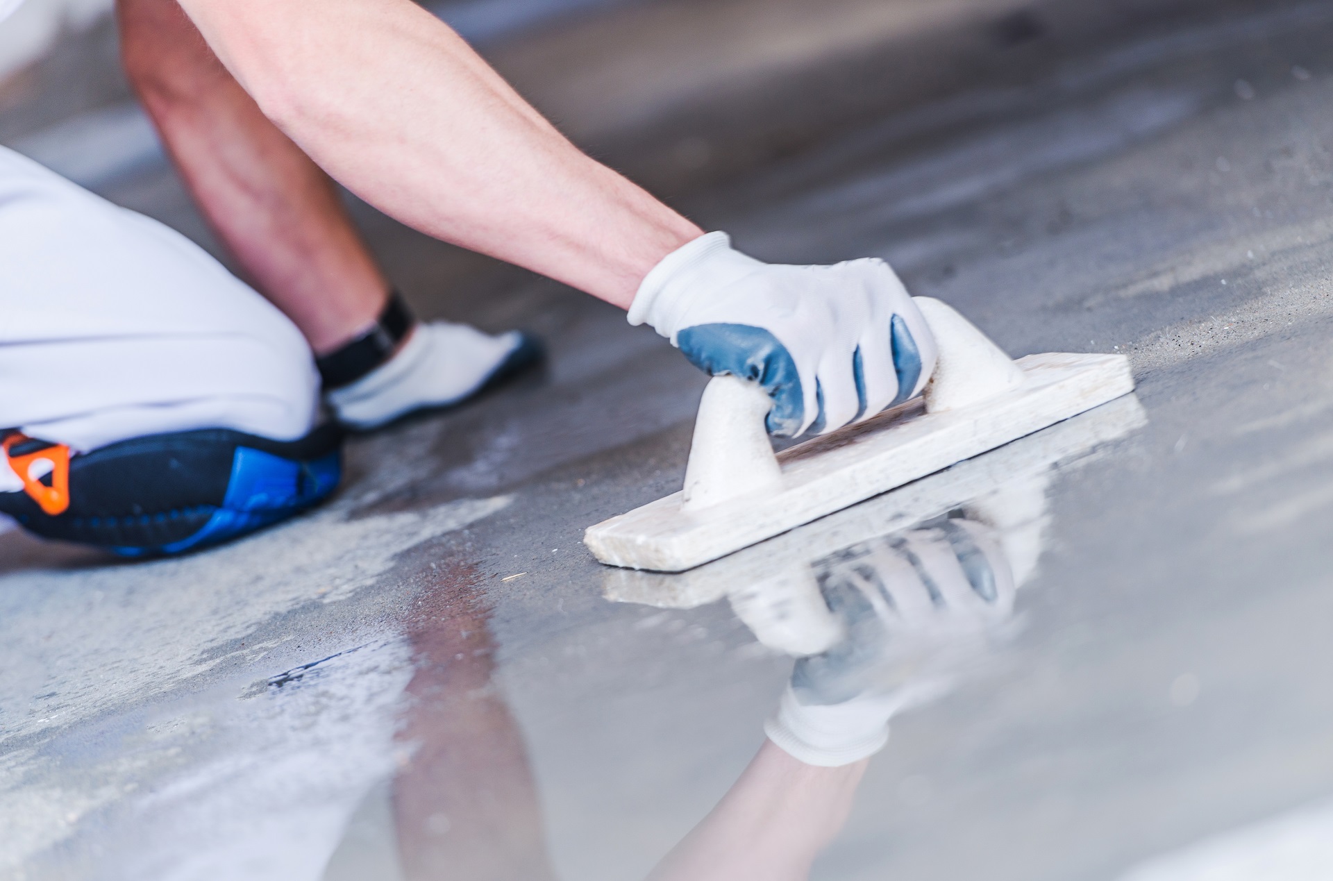 Concrete Floor Building. Watering and Leveling Floor Surface. House Construction Concept.